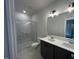 Modern bathroom features a double vanity, marble countertop, and glass-enclosed shower at 502 Yeowell Dr, Chapel Hill, NC 27514