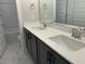 Bathroom with modern double vanity, sleek fixtures, and a glass-enclosed shower at 502 Yeowell Dr, Chapel Hill, NC 27514
