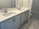 Modern bathroom featuring a double vanity, sleek fixtures, and a bathtub at 502 Yeowell Dr, Chapel Hill, NC 27514