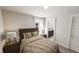 Cozy bedroom with a comfortable bed and a bathroom with white marble countertops in the background at 502 Yeowell Dr, Chapel Hill, NC 27514