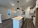 Bright open kitchen featuring a large center island and stainless steel appliances at 502 Yeowell Dr, Chapel Hill, NC 27514