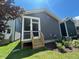 Rear exterior featuring a wooden porch with a screen, a blue siding and lawn at 502 Yeowell Dr, Chapel Hill, NC 27514