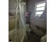 Bathroom with a tub/shower combo, toilet, and small window, all in need of repair at 505 S 15Th St, Erwin, NC 28339
