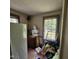 Bedroom filled with household items, two windows, and red flooring, showing a need for decluttering at 505 S 15Th St, Erwin, NC 28339