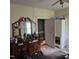 Bedroom with a vanity, wardrobe and multiple points of entry, needing decluttering and repair at 505 S 15Th St, Erwin, NC 28339