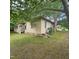 Exterior view of a house, framed by lush trees and greenery at 505 S 15Th St, Erwin, NC 28339