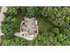 Aerial view of the house surrounded by mature trees, including driveway and surrounding landscaping at 512 Belmont Cir, Wake Forest, NC 27587