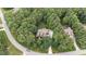 Breathtaking aerial view showcases a private estate enveloped in lush greenery and mature trees at 512 Belmont Cir, Wake Forest, NC 27587
