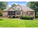 Expansive backyard featuring a screened porch, a wood deck, and lush green lawn at 512 Belmont Cir, Wake Forest, NC 27587