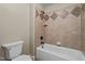Bathroom featuring a neutral-colored tile bathtub and tiled shower at 512 Belmont Cir, Wake Forest, NC 27587
