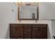 Bathroom with wooden cabinets, double sinks, large mirror and light fixtures at 512 Belmont Cir, Wake Forest, NC 27587
