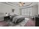 Bright bedroom features a ceiling fan, tray ceiling, large window with plantation shutters at 512 Belmont Cir, Wake Forest, NC 27587