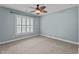 Spacious bedroom with a ceiling fan, neutral carpet, and a window with shutters at 512 Belmont Cir, Wake Forest, NC 27587