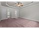Spacious bedroom features a ceiling fan, tray ceiling, with access to bath and closet at 512 Belmont Cir, Wake Forest, NC 27587