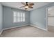 Bedroom featuring a ceiling fan and window with plantation shutters at 512 Belmont Cir, Wake Forest, NC 27587