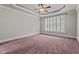 Spacious bedroom features a ceiling fan, tray ceiling, large window with plantation shutters at 512 Belmont Cir, Wake Forest, NC 27587