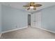 Bedroom with neutral carpet, ceiling fan, and an adjoining bathroom at 512 Belmont Cir, Wake Forest, NC 27587