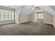Finished bonus room with a neutral carpet, white trim, and two windows at 512 Belmont Cir, Wake Forest, NC 27587