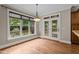 Elegant dining area featuring hardwood floors, large window, and glass-paneled doors to the deck at 512 Belmont Cir, Wake Forest, NC 27587
