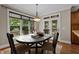 Elegant dining area with a large window, french doors to the deck, and hardwood floors at 512 Belmont Cir, Wake Forest, NC 27587