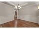 Bright formal dining room with wainscoting and hardwood floors at 512 Belmont Cir, Wake Forest, NC 27587