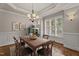 Bright dining room with hardwood floors, wainscoting, and a large window with plantation shutters at 512 Belmont Cir, Wake Forest, NC 27587