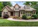 Charming exterior of a two-story home with stone accents, manicured landscaping, and a welcoming walkway at 512 Belmont Cir, Wake Forest, NC 27587