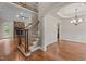 Elegant foyer with hardwood floors, staircase with decorative iron railings, and views of the living and dining areas at 512 Belmont Cir, Wake Forest, NC 27587
