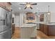 Well-lit kitchen boasts stainless steel appliances, wood cabinets, granite countertops, and an island at 512 Belmont Cir, Wake Forest, NC 27587