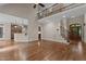 Open living space featuring hardwood floors, staircase, and view into the kitchen area at 512 Belmont Cir, Wake Forest, NC 27587