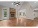 Bright living room features a stone fireplace, hardwood floors, and entry to a deck at 512 Belmont Cir, Wake Forest, NC 27587