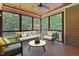 Screened porch with wood ceiling, wood floor, and seating overlooking the backyard at 512 Belmont Cir, Wake Forest, NC 27587