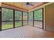 Relaxing screened porch with a wood floor and views of the wooded backyard at 512 Belmont Cir, Wake Forest, NC 27587