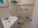 A functional bathroom features a single sink vanity, toilet, and wall-mounted shelving for storage at 520 Charlotte Ave, Rocky Mount, NC 27804