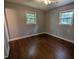A cozy bedroom features hardwood floors, neutral wall color, and natural light from two windows at 520 Charlotte Ave, Rocky Mount, NC 27804