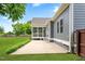 Exterior shot of the house with a screened porch, concrete patio, and green lawn at 532 Joe Collins Rd, Lillington, NC 27546