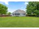 Expansive backyard view featuring a well-manicured lawn and a charming screened porch, perfect for outdoor relaxation and entertainment at 532 Joe Collins Rd, Lillington, NC 27546