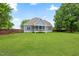 This is a view of the expansive backyard and screened porch offering an ideal space for outdoor enjoyment and leisure at 532 Joe Collins Rd, Lillington, NC 27546