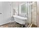 Bathroom showcasing a clawfoot tub and stand-up shower with natural light at 532 Joe Collins Rd, Lillington, NC 27546