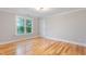 This bedroom has hardwood floors, recessed lighting, and a large window at 532 Joe Collins Rd, Lillington, NC 27546