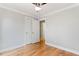 This bedroom has hardwood floors, a ceiling fan, and a large closet at 532 Joe Collins Rd, Lillington, NC 27546