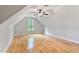 Attic bedroom features light hardwood floors, a ceiling fan, and a window with natural light at 532 Joe Collins Rd, Lillington, NC 27546