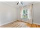 Cozy bedroom with natural light, hardwood flooring, and neutral paint at 532 Joe Collins Rd, Lillington, NC 27546