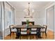 Traditional dining room with hardwood floors, wainscoting, a stylish chandelier, and a dark wood dining table at 532 Joe Collins Rd, Lillington, NC 27546