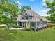 Beautifully landscaped home featuring mature trees, lush shrubs, and elegant stonework, creating a welcoming curb appeal at 532 Joe Collins Rd, Lillington, NC 27546