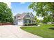 Landscaped gray home showcasing an attached garage, circular driveway, and a well-maintained lawn at 532 Joe Collins Rd, Lillington, NC 27546