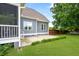 Exterior shot of the house with a screened porch, concrete patio, and green lawn at 532 Joe Collins Rd, Lillington, NC 27546