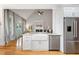 Bright kitchen with a farmhouse sink, stainless steel appliances, and hardwood flooring overlooking the living room at 532 Joe Collins Rd, Lillington, NC 27546
