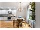 Bright breakfast nook featuring a modern chandelier, wood table and lots of natural light at 532 Joe Collins Rd, Lillington, NC 27546