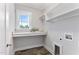 Functional laundry room with built-in shelves, window, and marbled countertops at 532 Joe Collins Rd, Lillington, NC 27546